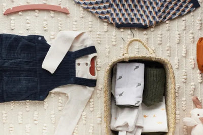 A variety of baby clothes and bodysuits all made with organic cotton and made in America.