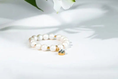 A white beaded bracelet. 