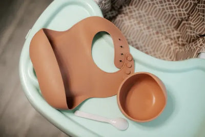 A modern brown bib sits on a table.