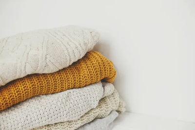 Five blankets that were made in America are piled on top of each other.