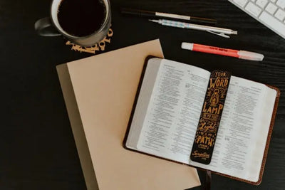 A bookmark and notepad on a table.