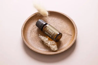 Organic essential oils that were handcrafted in America sit on a wooden plate.