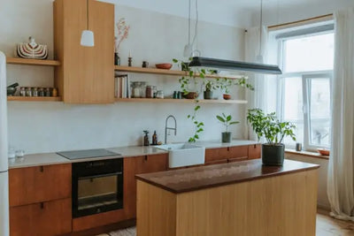 A modern kitchen with brown cabinets with storage for spices, pans and other kitchen essentials.