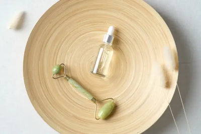 Organic serums and skin treatments sitting on a crafted brown plate. The serums and skin treatments were made in America. 