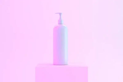 A bottle holding organic shampoo sits on a shelf. 