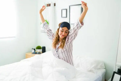 A woman waking up and taking off her sleeping mask that was sewn in Pennsylvania. 