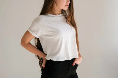 A woman wearing a white t-shirt that is labeled 
