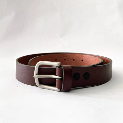 The Rogue Industries Chamberlain Leather Belt, 1.25 wide with a silver metal buckle, is shown coiled on a white background.