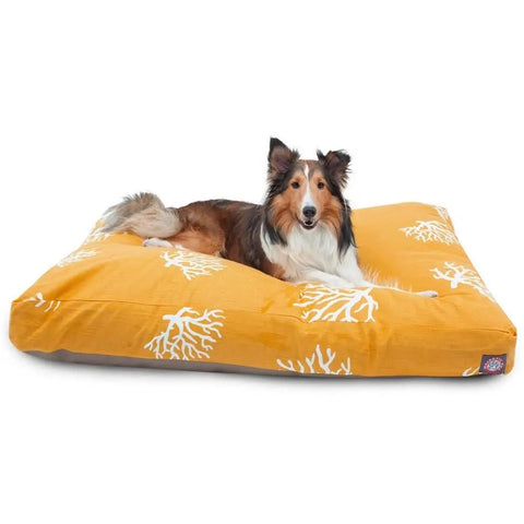 A brown and white dog with pointy ears rests on the Majestic Pet Coral Rectangle Dog Bed, featuring a white coral pattern. This washable bed makes cleanup easy and convenient for pet owners.