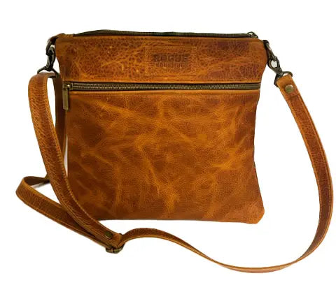 The Ellis River Crossbody Bag in Leather by Rogue Industries features a long adjustable strap, front zipper pocket, and the Rogue Industries name embossed on the upper front.