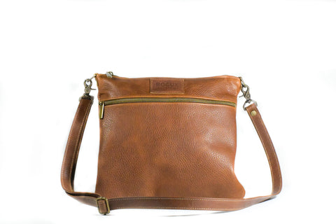 The Rogue Industries Ellis River Crossbody Bag in Leather, crafted in Maine, showcases a long adjustable strap and front zip pocket, displayed against a white background.