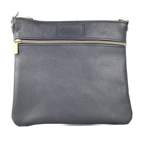 The Ellis River Crossbody Bag in Leather by Rogue Industries features a gold front zipper, embossed logo, textured surface, and minimalist design. This timeless bag is crafted from genuine leather and made in Maine.