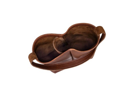 The Urban Southern Urban Dual Wine Tote is a brown leather bag with two spacious open compartments, a curved top edge, and a single shoulder strap, shown from above with an empty interior against a white background.