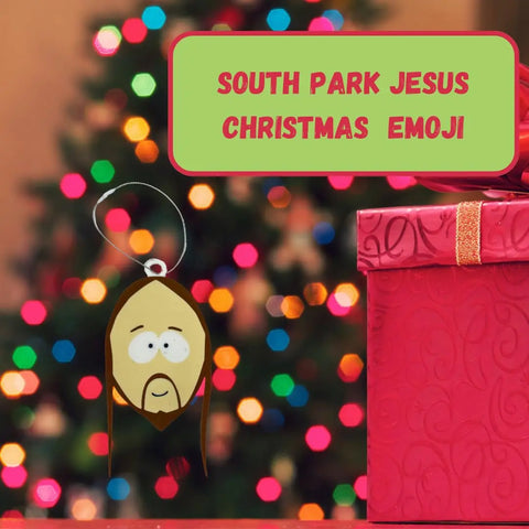 A Christmas tree glows in the background as a South Park-style Jesus emoji ornament by Chatelet Manufacturing hangs next to a pink gift. Text: Funny Gag Gift Christmas Ornament | Perfect Dirty Santa Gift | Made in USA.