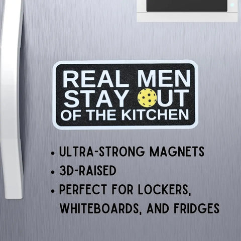 A black Chatelet Manufacturing magnet reads REAL MEN STAY OUT OF THE KITCHEN with a yellow dot. Ultra-strong, 3D-raised, perfect Pickleball fridge magnet for lockers, whiteboards, fridges. Made in USA—funny gift for Pickleball players.