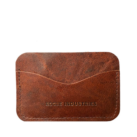 The Moose Leather Card Case by Rogue Industries is crafted in Maine from brown moose leather with visible stitching, embossed branding, and features two curved card slots for easy access.