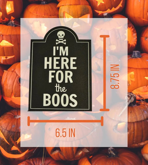 The Im Here for the Boos Halloween Bar Sign Decor by Chatelet Manufacturing is a black rectangular sign (8.75 x 6.5) with skull and crossbones—an ideal spooky touch above a pumpkin display at your Halloween party. Made in USA.