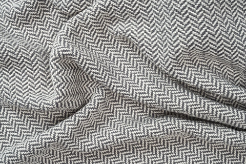 A close-up of the soft, textured surface and V-shaped weave of the Herringbone Weave Cotton Blanket from American Blossom Linens—ideal as a cozy layer or heirloom-quality accent.