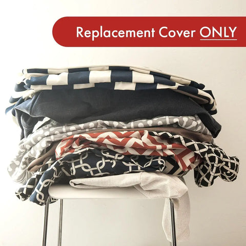 A stack of patterned fabric covers sits on a white chair, with a red banner above that reads Replacement Cover ONLY—perfect for refreshing your Majestic Pet Villa Bagel Dog Bed - Personalized.