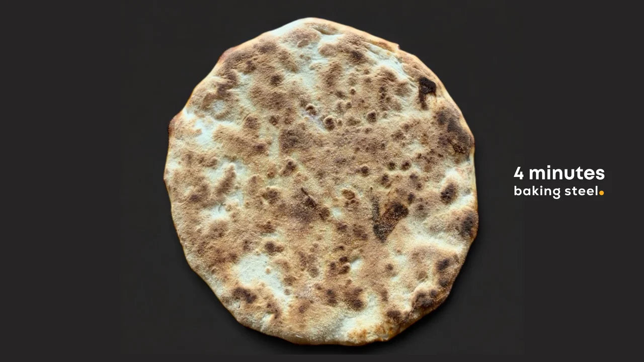 Round flatbread with a dark brown color on a black background, labeled '4 minutes baking steel'.