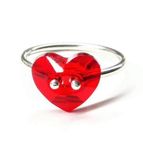 The I Love You Crystal Heart Bling Ring by Alexa Martha Designs features a sterling silver band with a red heart-shaped centerpiece and two small holes—making it a charming Valentine’s Day gift.