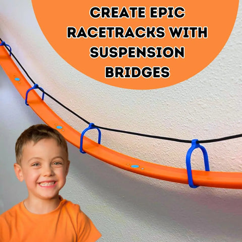 A smiling boy stands by a racetrack with bridges, attached to the wall. Text: Build epic tracks with Chatelet Manufacturings Suspension Bridge Kit—includes 10 supports, rope & wall connectors—compatible with Hot Wheels Racetracks. Made in USA.