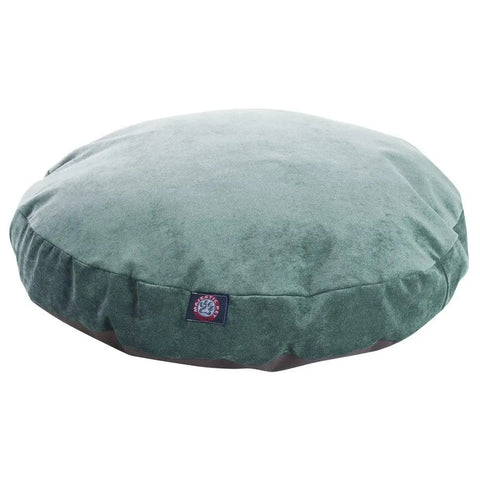 The Majestic Pet Villa Round Dog Bed is a green velvet pet bed with a washable, removable cover and a small blue and red fabric tag on the side, shown against a white background.