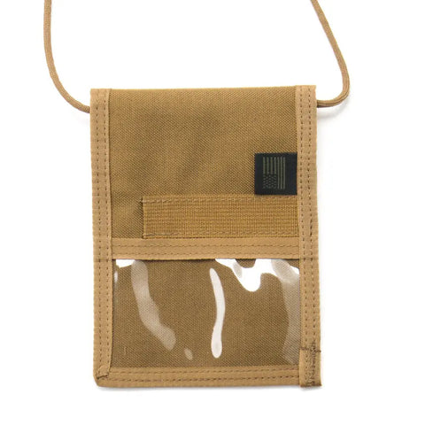 The MIS ID Passport Case in coyote brown Cordura nylon features a clear front pocket, horizontal loop, and a black patch. Designed as a travel document organizer, it hangs from a matching tan cord for convenience.